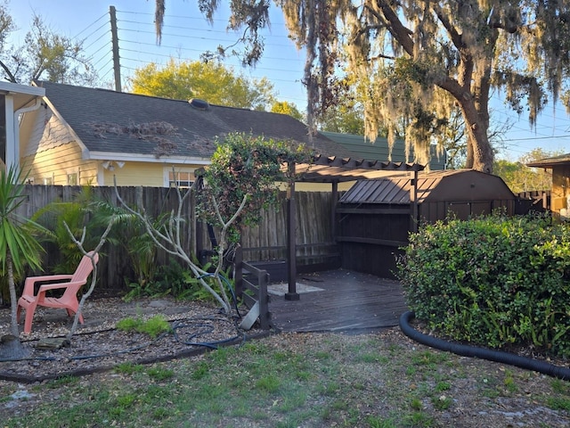 view of yard featuring an outbuilding, a shed, and fence