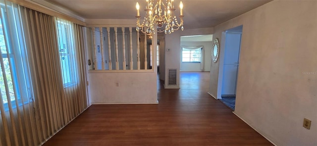 hall featuring visible vents, an inviting chandelier, and wood finished floors