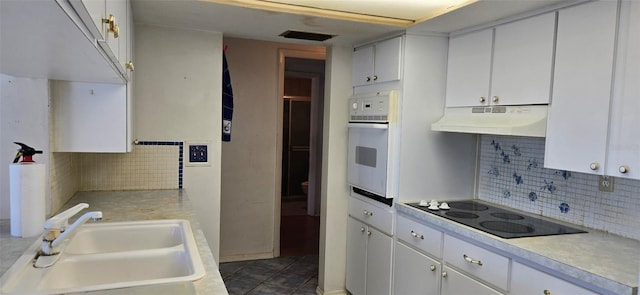 kitchen with visible vents, oven, a sink, under cabinet range hood, and black electric stovetop