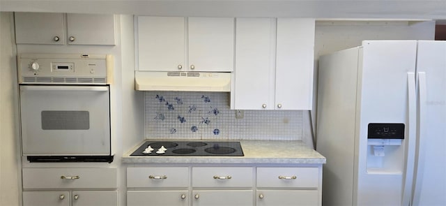 kitchen with white appliances, light countertops, white cabinets, under cabinet range hood, and tasteful backsplash