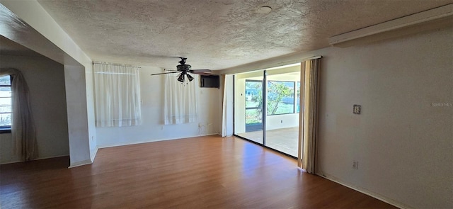 spare room featuring a ceiling fan, wood finished floors, and a textured ceiling