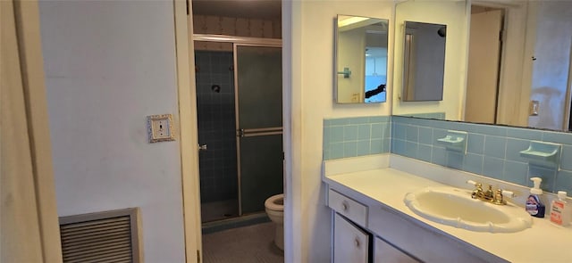 bathroom featuring tasteful backsplash, visible vents, a stall shower, and toilet