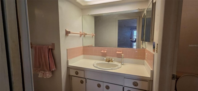 bathroom with decorative backsplash and vanity