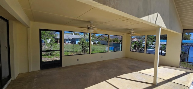 unfurnished sunroom with a healthy amount of sunlight and a ceiling fan