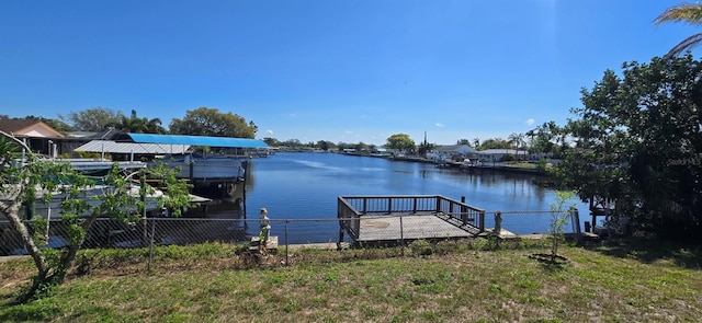 dock area featuring fence and a water view