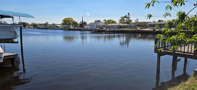 view of dock with a water view and a residential view