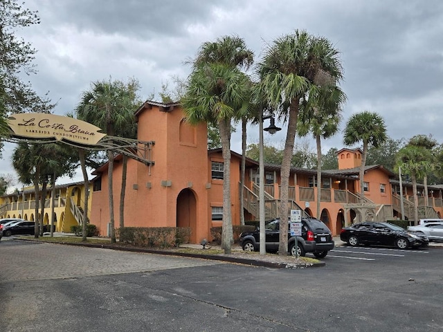 view of building exterior with uncovered parking