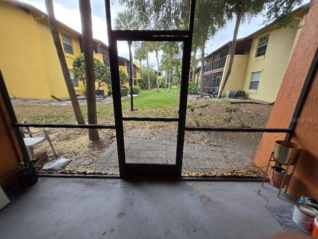 doorway with unfinished concrete flooring