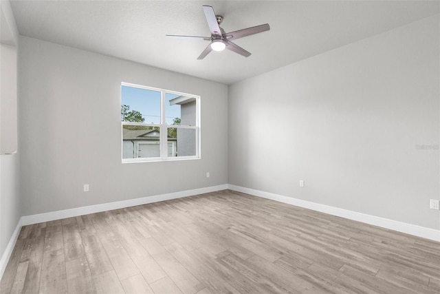 unfurnished room with a ceiling fan, baseboards, and light wood finished floors