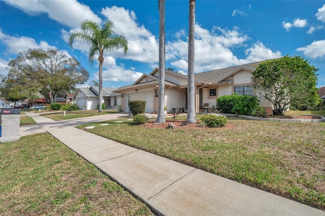 ranch-style home with a front lawn, a residential view, driveway, and an attached garage