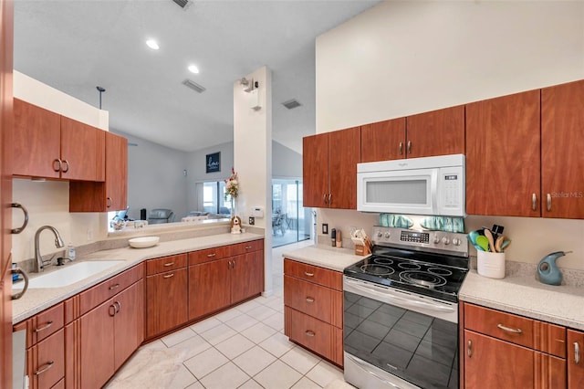 kitchen with electric stove, light countertops, visible vents, white microwave, and a sink