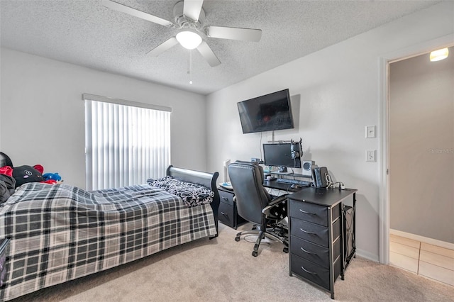 bedroom featuring a textured ceiling, ceiling fan, light tile patterned floors, light colored carpet, and baseboards