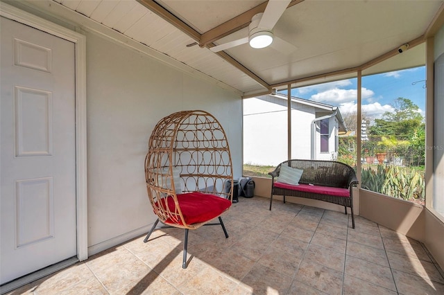 sunroom / solarium with a healthy amount of sunlight and ceiling fan