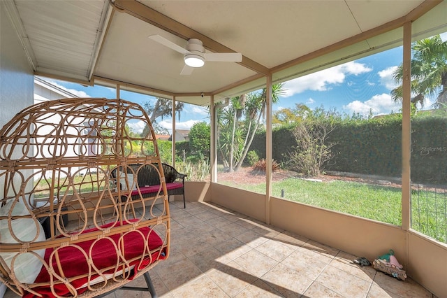 sunroom featuring ceiling fan