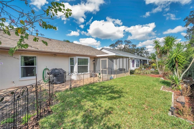 exterior space with a yard, a shingled roof, fence, and stucco siding