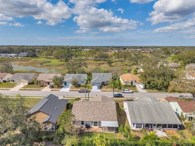 drone / aerial view with a water view and a residential view