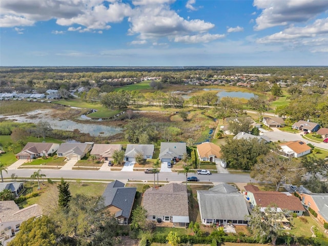 drone / aerial view with a residential view and a water view