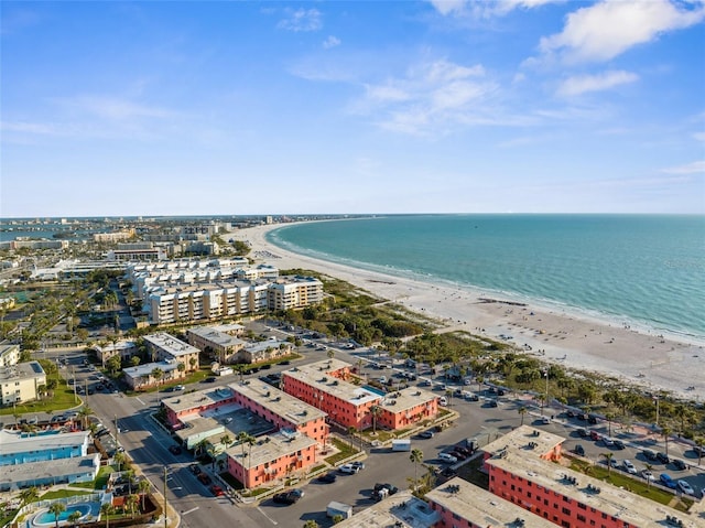 drone / aerial view featuring a water view, a city view, and a view of the beach