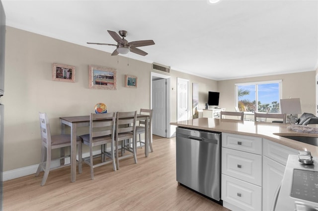 kitchen with light countertops, open floor plan, white cabinets, and stainless steel dishwasher