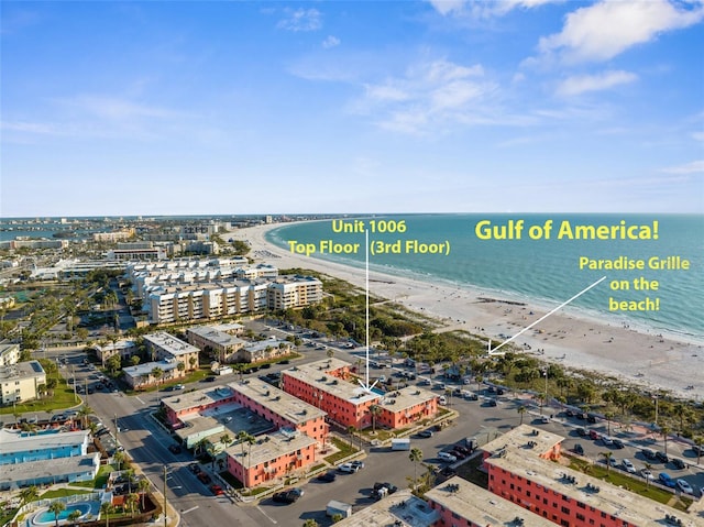 birds eye view of property with a view of city, a water view, and a beach view