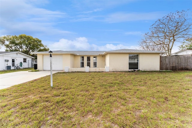 ranch-style home featuring a garage, concrete driveway, fence, a front lawn, and brick siding