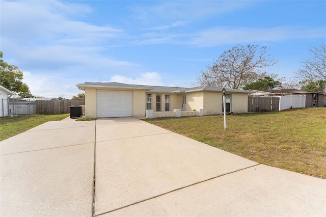 ranch-style home with driveway, a garage, central AC unit, fence, and a front yard