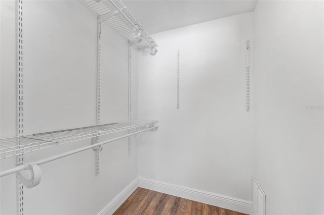 walk in closet with dark wood-type flooring and visible vents