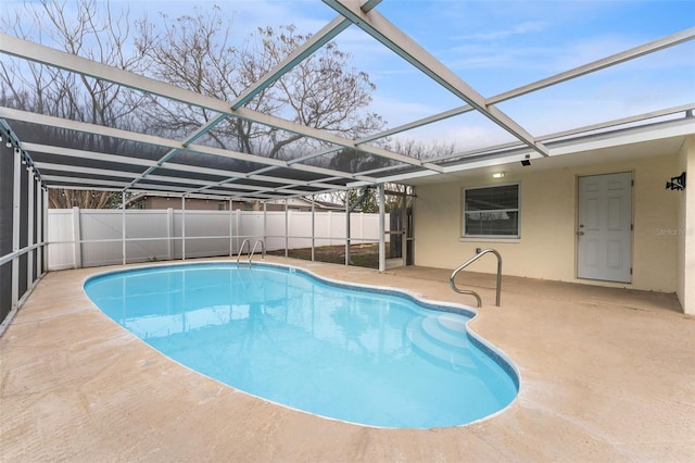 view of pool with glass enclosure, a fenced backyard, a fenced in pool, and a patio