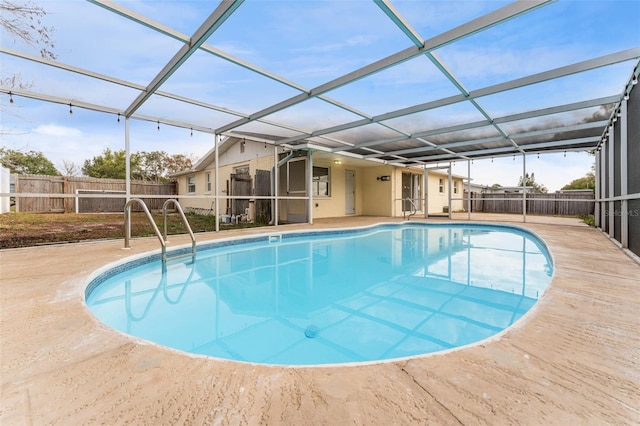 view of pool with a fenced in pool, a patio area, glass enclosure, and a fenced backyard