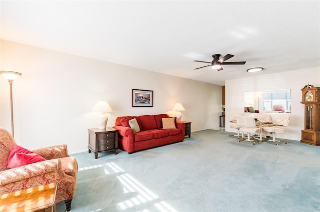 carpeted living room with a ceiling fan