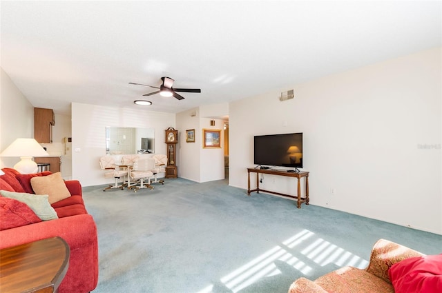 living room featuring carpet, visible vents, and ceiling fan