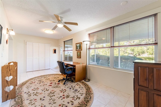 office area with a ceiling fan, a textured ceiling, and light tile patterned flooring