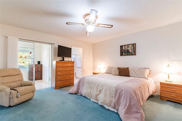 bedroom with ensuite bath, ceiling fan, a textured ceiling, and light colored carpet