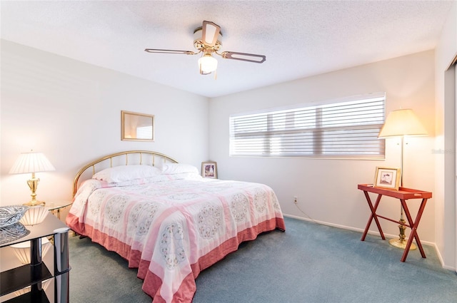 bedroom with a ceiling fan, dark colored carpet, a textured ceiling, and baseboards