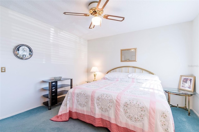 carpeted bedroom with a ceiling fan and baseboards