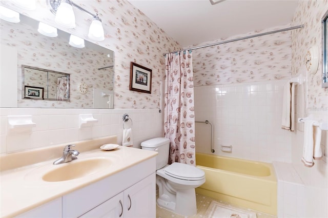 full bath with wallpapered walls, wainscoting, toilet, shower / bath combo with shower curtain, and tile walls