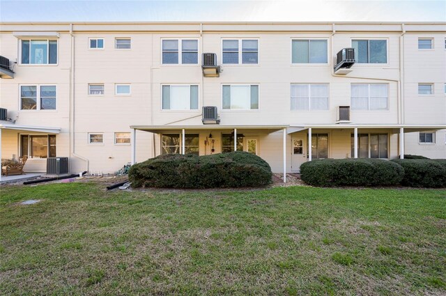 view of property featuring a front yard and central air condition unit