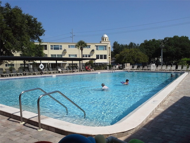 pool with fence and a patio