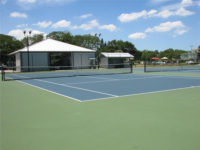 view of tennis court featuring fence