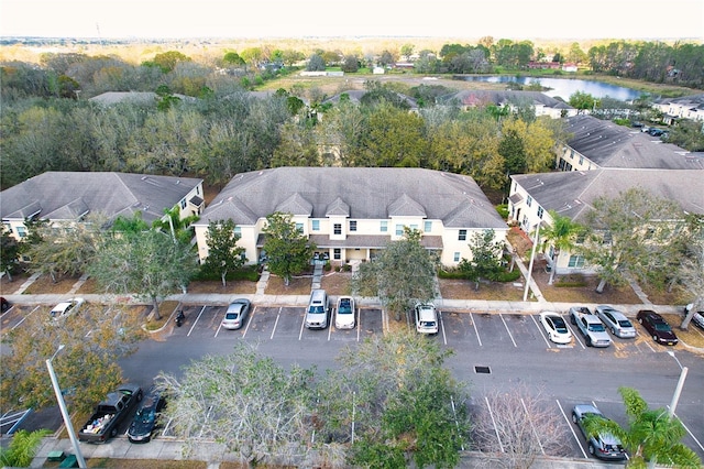 bird's eye view featuring a water view and a residential view