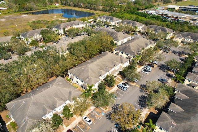 drone / aerial view featuring a water view and a residential view