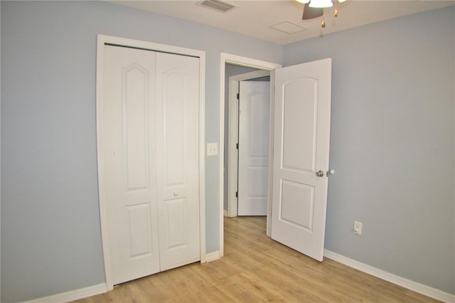 unfurnished bedroom with light wood-style flooring, a closet, visible vents, and baseboards