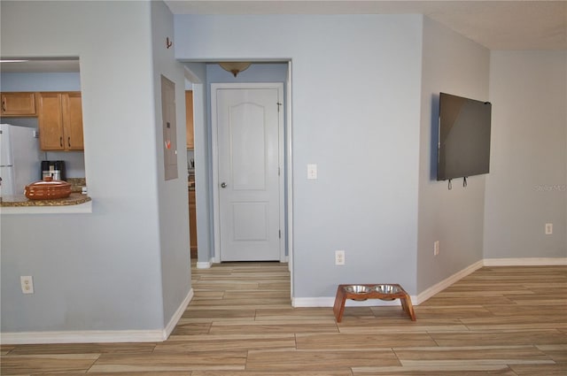 interior space featuring baseboards and wood finish floors