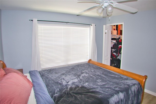 bedroom featuring ceiling fan and a closet