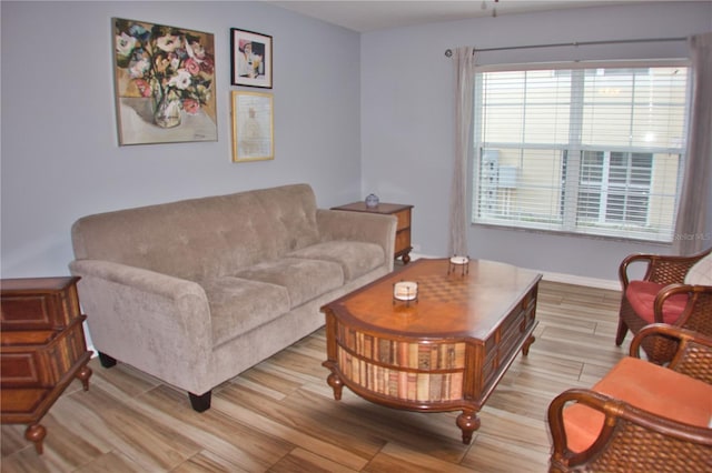 living area with light wood-style flooring and baseboards