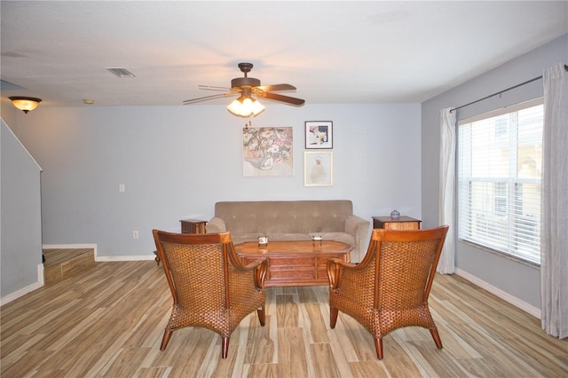 interior space featuring light wood-style flooring, visible vents, baseboards, and ceiling fan