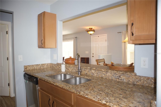 kitchen with dishwasher, a peninsula, a sink, and light stone countertops