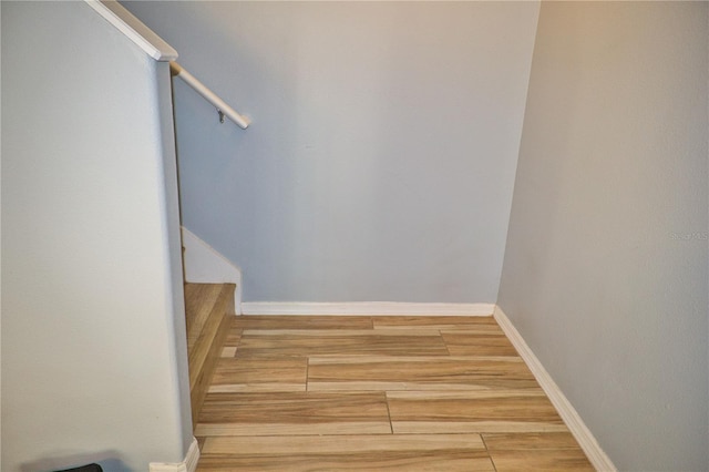 interior space featuring baseboards and wood finished floors