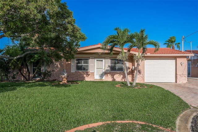 ranch-style house featuring an attached garage, a front yard, decorative driveway, and stucco siding