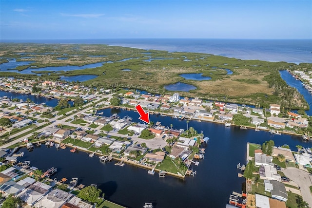 drone / aerial view featuring a residential view and a water view